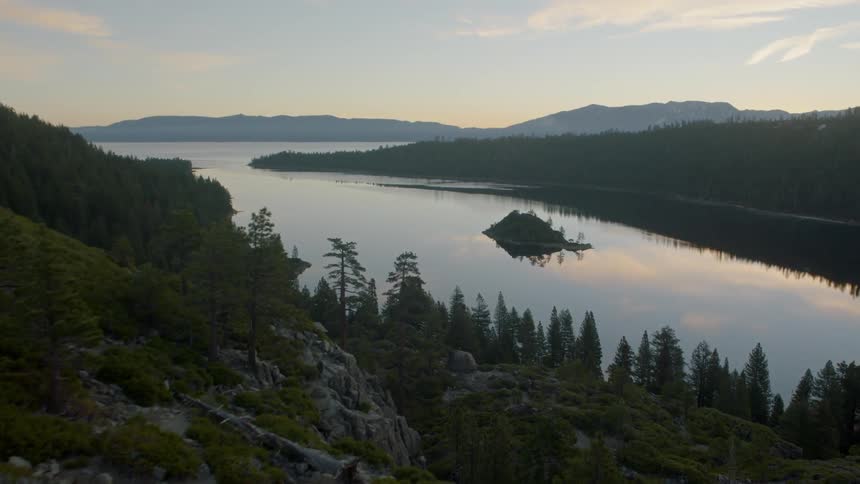 Skimming along a rock face to reveal Emerald Bay at dawn