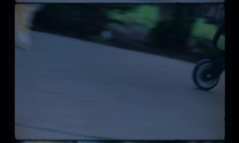 Closeup of the feet of a person running and pushing a shopping cart