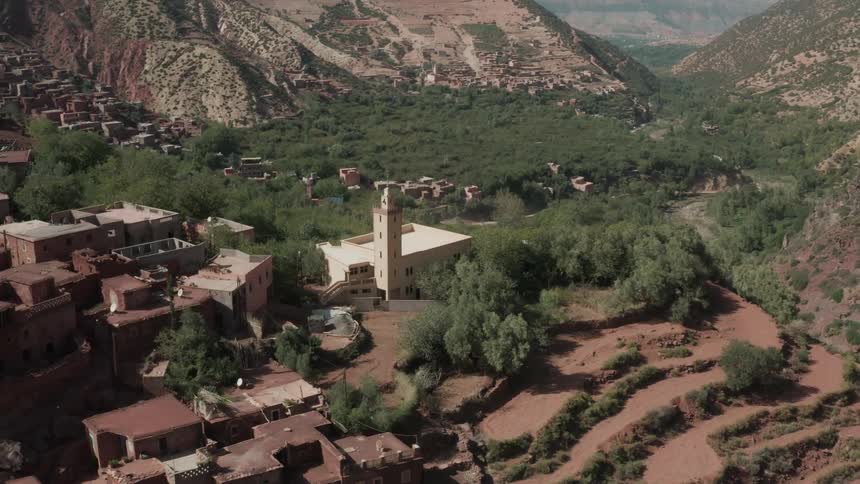Church at the peak of a mountain surrounded by houses