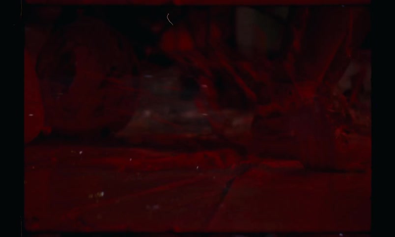 Person splatters paint while dancing on thick multi colored puddle of paint