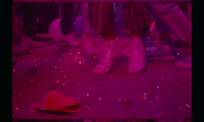 Closeup of peoples legs in a dancing circle at a party