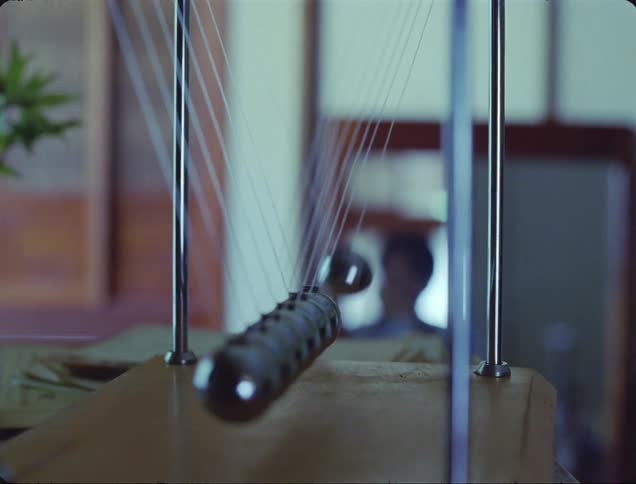 A pendulum with some metal balls hitting each other