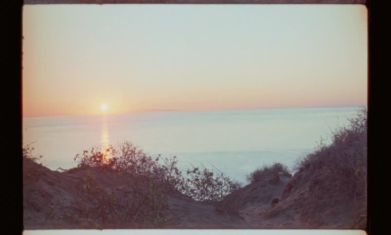 A person runs to a horizon landscape with the sea and the bright sun in the sky