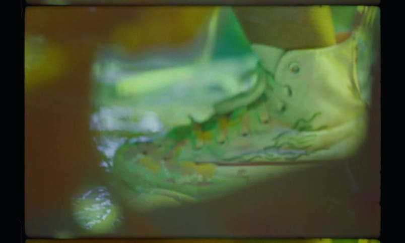 A person wearing sneakers dances around and splashes paint