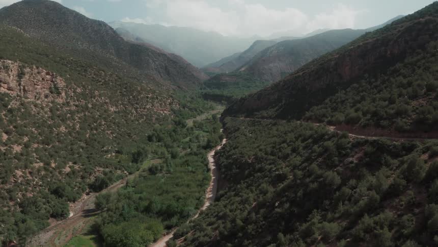 Aerial view of a road through a valley in the mountains