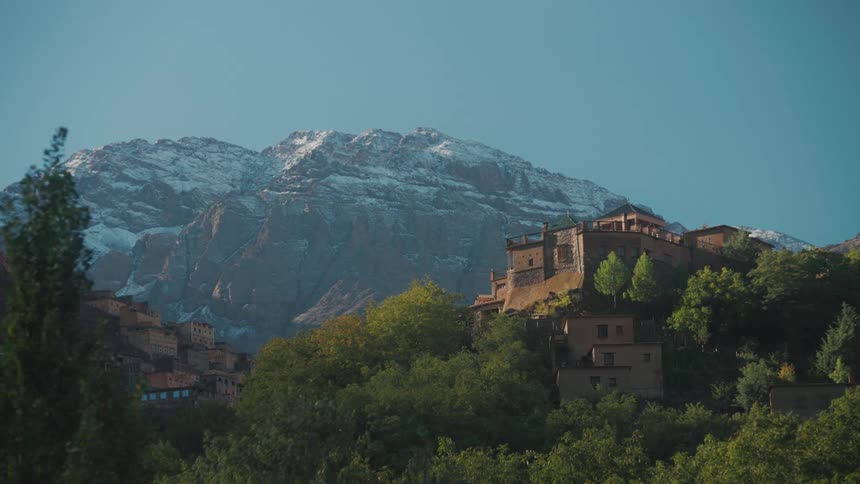 The village is nestled in a valley surrounded by snowcapped peaks