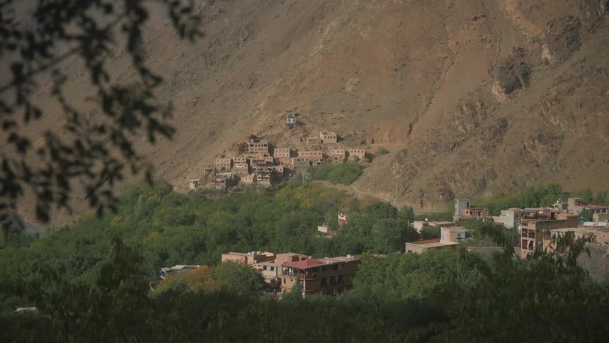A village of houses is at the base of a mountain