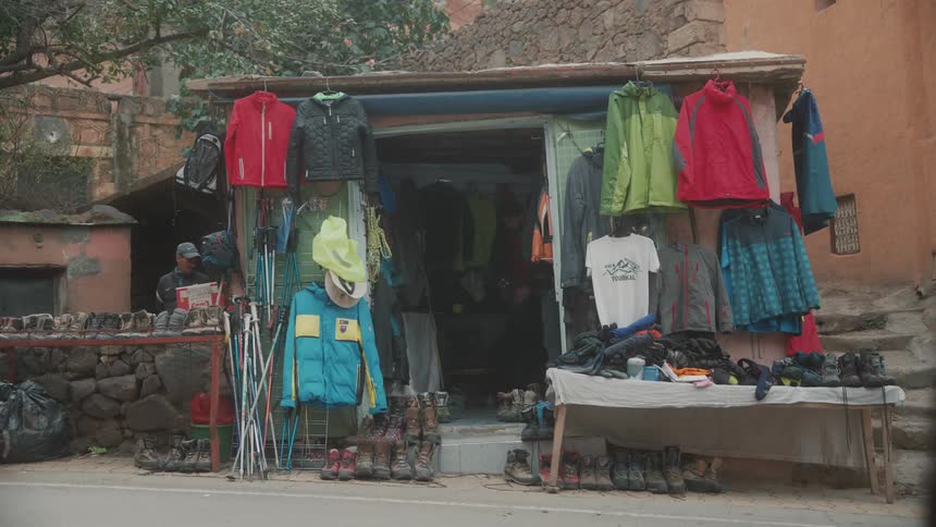 Shoes and hanged clothes by the roadside at midday