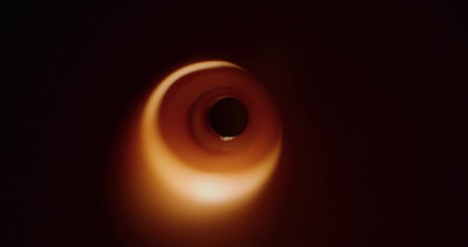 A flare of light passing through a tunnel that is completely dark