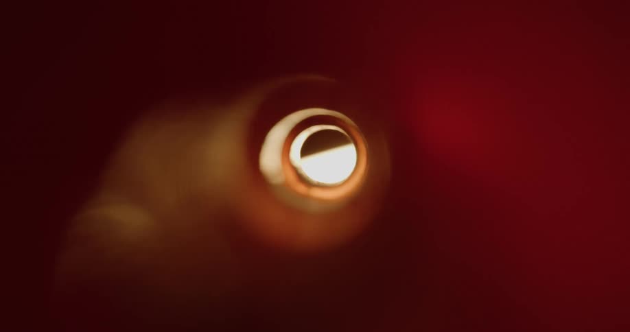 A tube with a hole at the end and lights passing through its segment