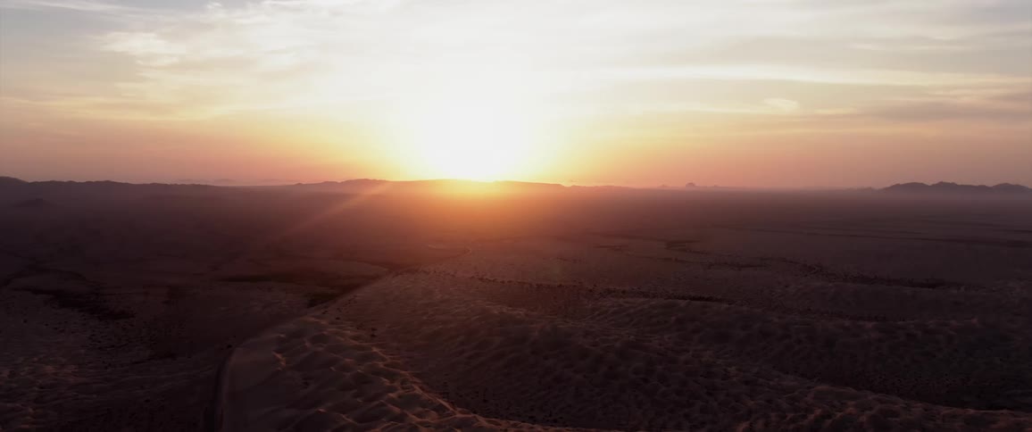 Aerial landscape of natural fields with the sunrise on the horizon