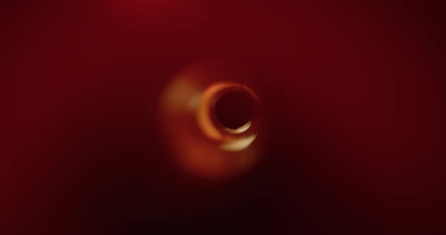 Inside an abstract funnel with reflections of external lights creating shadows