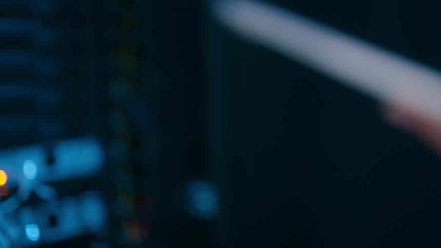 A person touching a screen and in front there is a device with several blinking leds