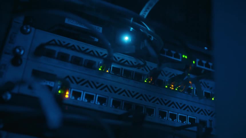 The backside of a server full of ethernet ports and blinking led lights