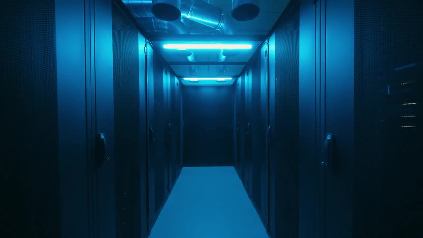 A corridor with several doors on the sides and the ceiling lights are turned off