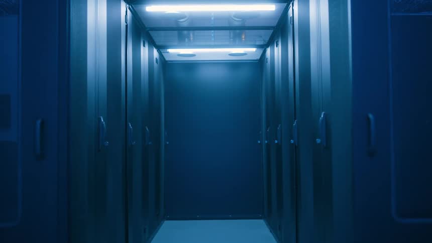 A hallway with some identical doors on both sides and a light on the ceiling