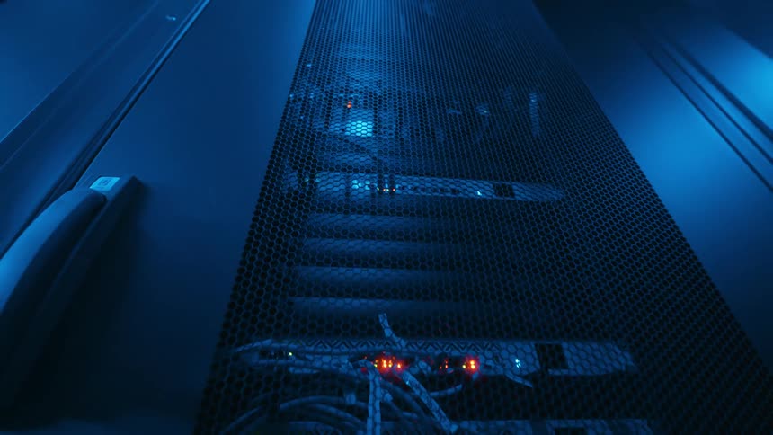 A server room filled with eqipment running with blinking lights