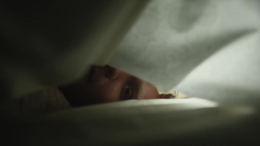 A face of a person who is under a blanket