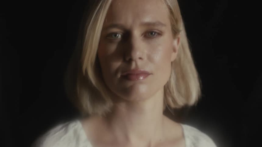 Close up of womans face as light fades