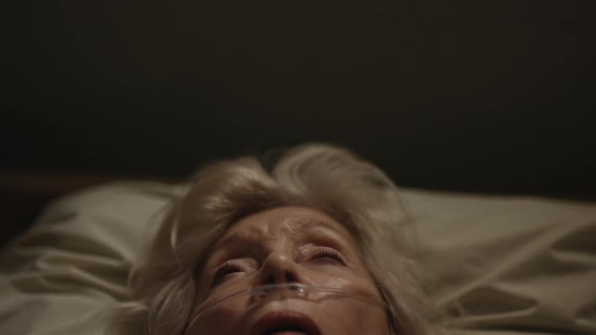 Elderly woman lay on the bed with nasogastric tube in her nose
