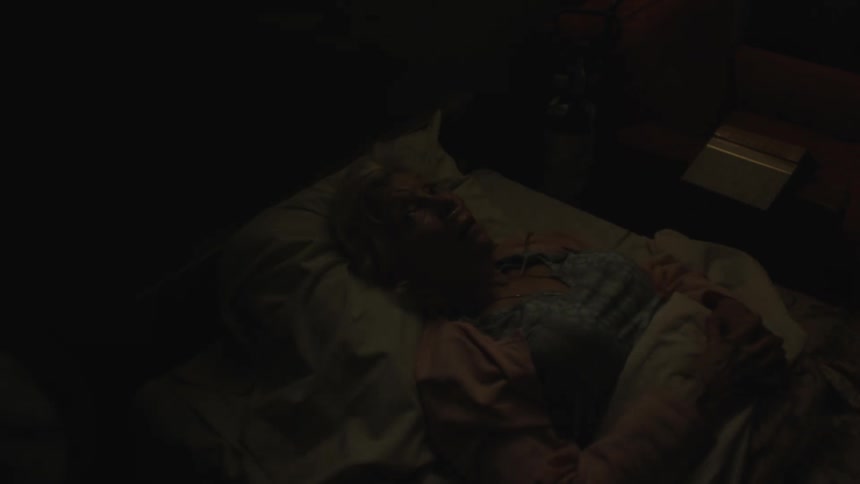 An elderly woman on the sickbed crying