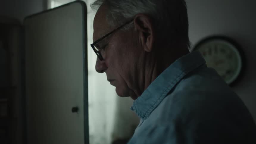 A man in the bathroom getting medicine