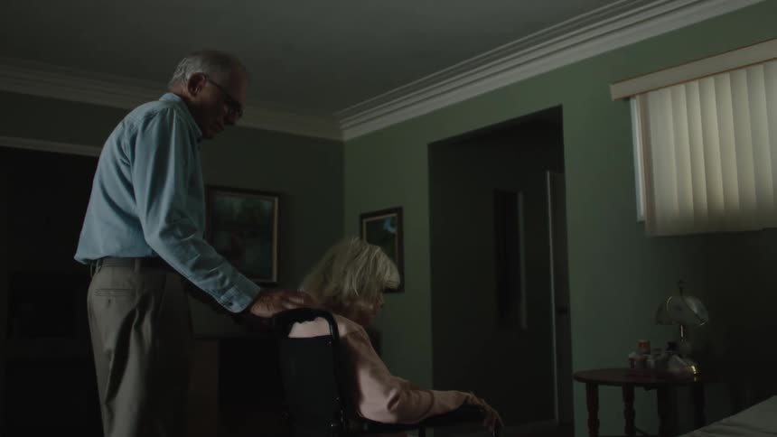A man pushing a woman in a wheelchair
