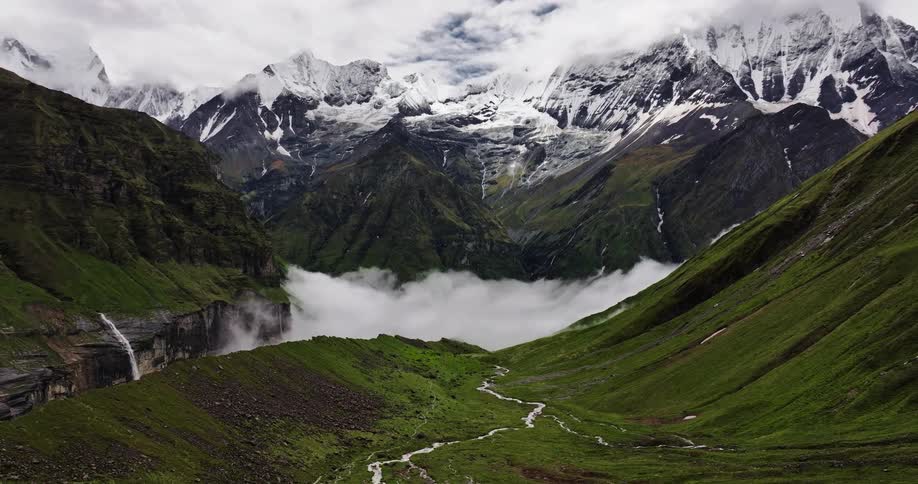 Aerial of a valley with cliff and stream on a cloudy day