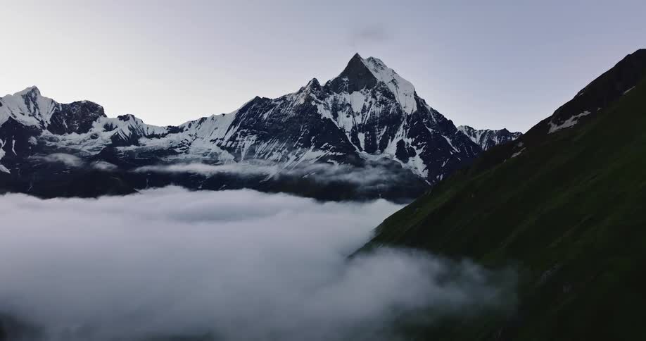 A landscape of high mountains that are above the clouds