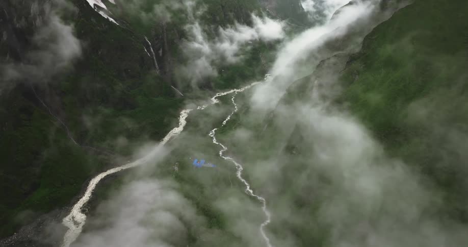 Aerial of the river between mountains with fog