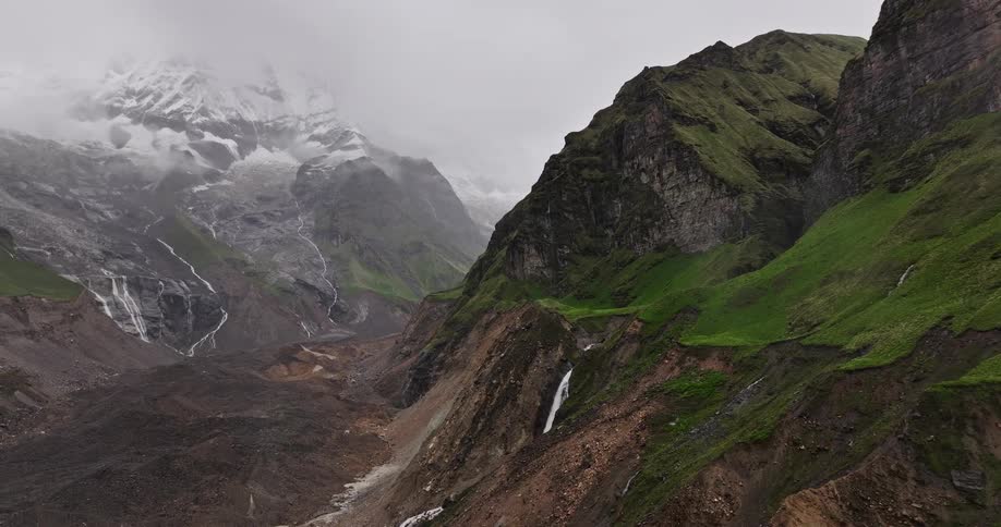 The mountains are covered with green and snow