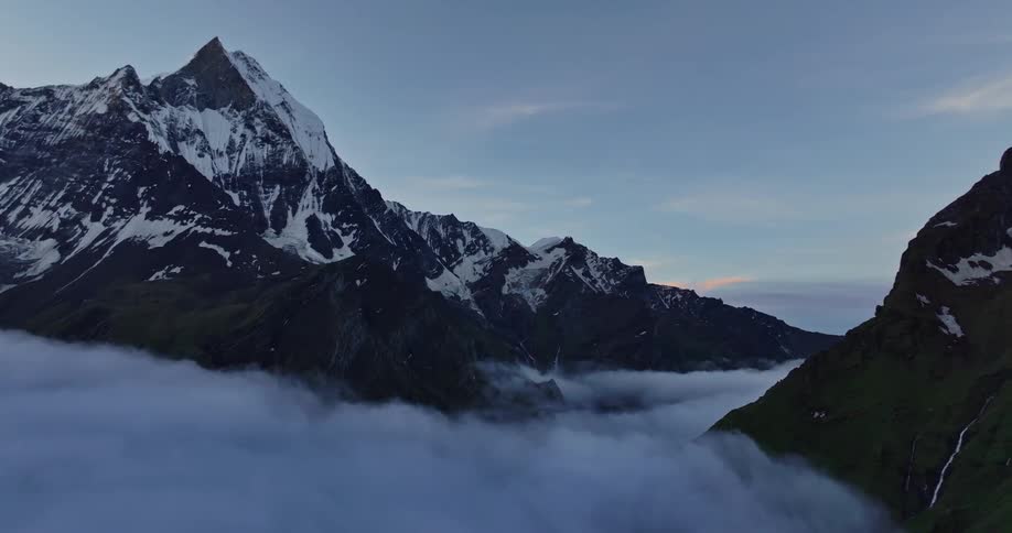 Aerial panorama of clouds amidst snowcovered mountains