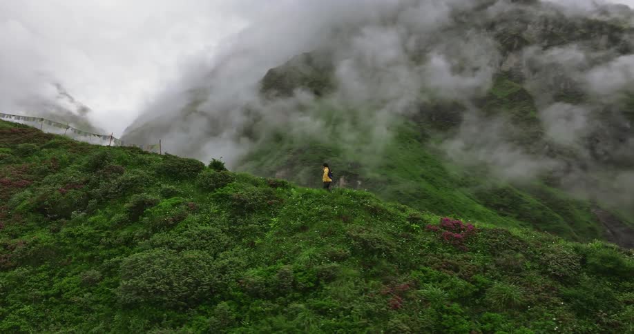 A man hiking on the mountain covered in fog