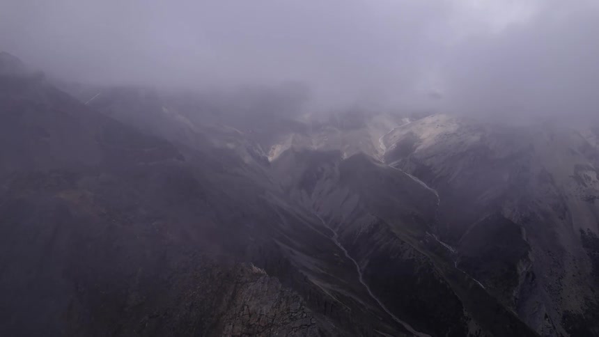 Aerial of a valley between mountains and fog