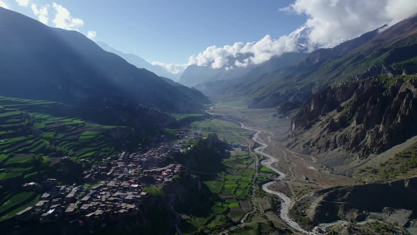 Aerial panoramic view of a mountain range on a sunny day