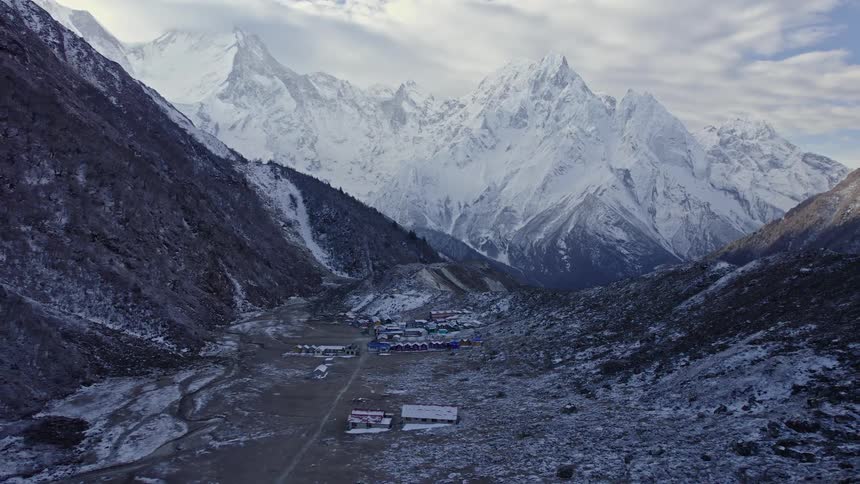 A village on top of a mountain with snow on the surface