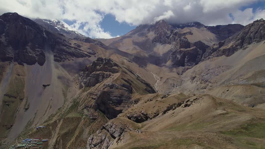 Aerial panoramic view of a mountain range and its geological peaks