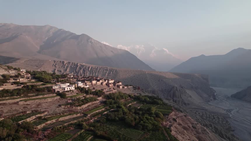 A small village of houses in a region with many mountains and little vegetation