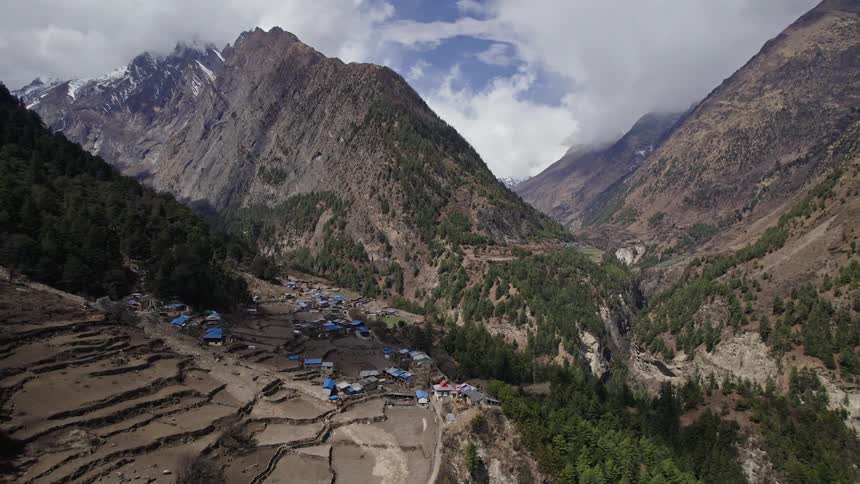Village on a plateau surrounded by a mountain range