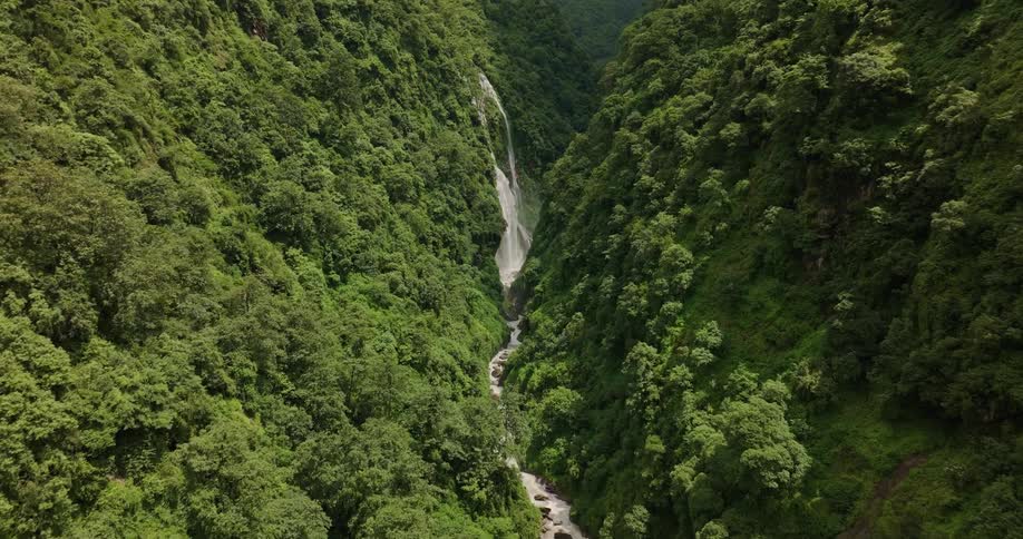 A waterfall is on the green mountain