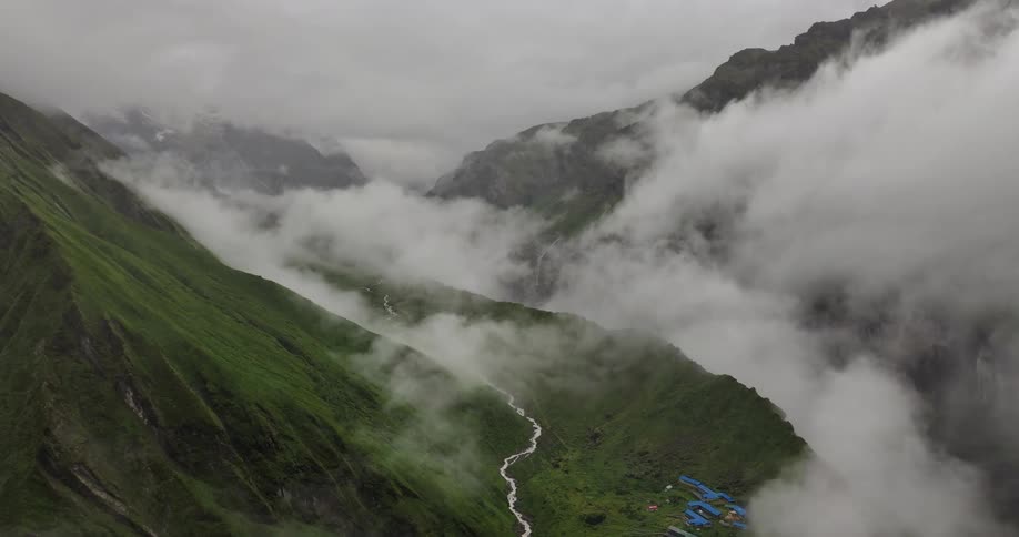 Aerial panorama amidst a slope of mountains at cloud level