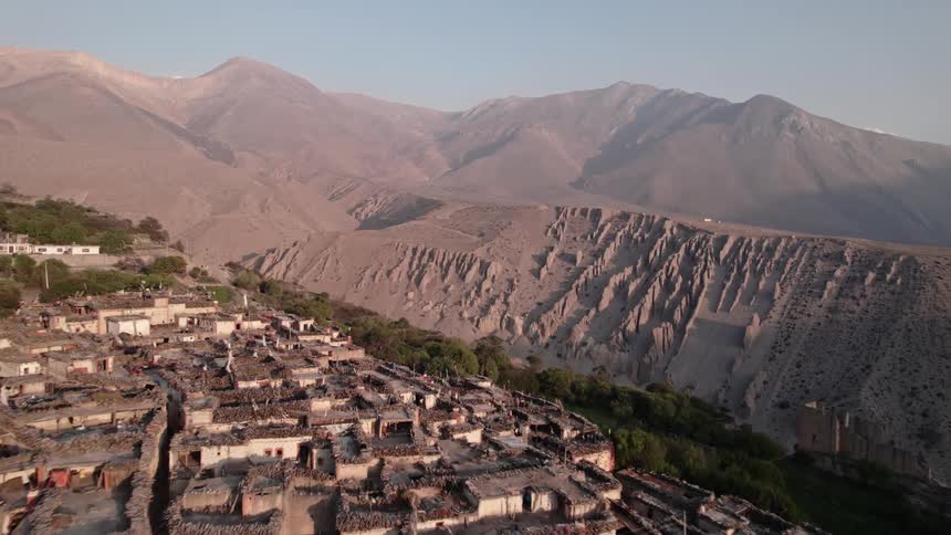 Village on a plateau surrounded by mountainous dunes amidst nature