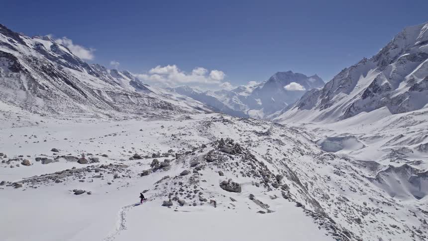 A person hiking in the snow on the mountain trail