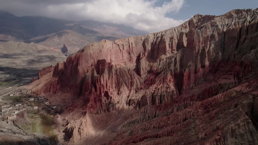 Aerial panorama of a mountain range with geological formations and erosions