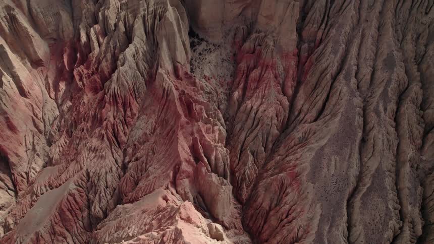 Aerial of pink rock formations in a canyon