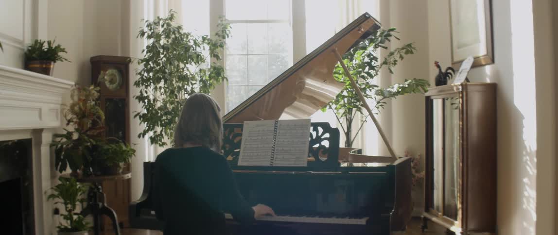 Woman playing  her piano on a sunny day
