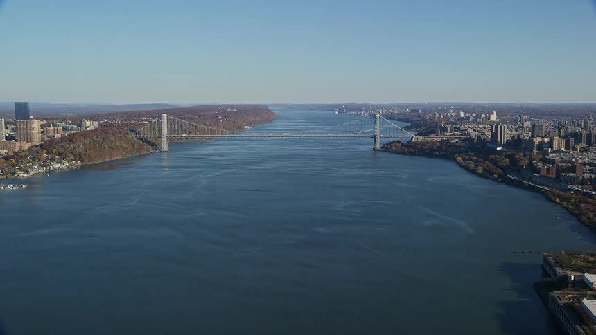 A bridge linking two city with cars going by it
