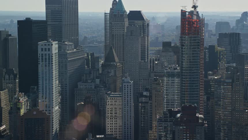 Building under construction towers over many downtown buildings