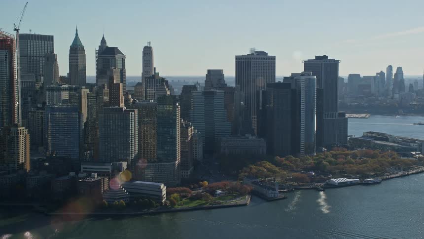 Aerial view and panorama of a metropolis with skyscrapers along the waterfront in a morning sky