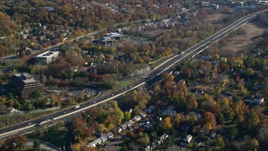 Aerial view of an urban city next to a highway